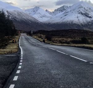 Empty road leading towards mountains