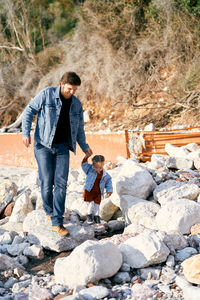 Father and son on rock