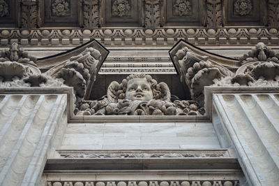 Low angle view of statue against historic building