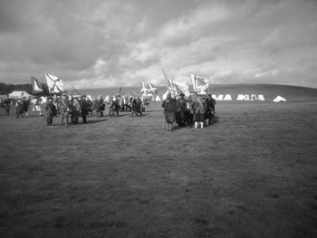 Group of people on land against sky
