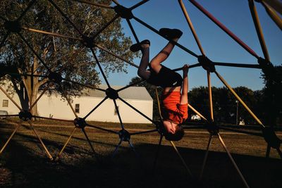 Full length of boy playing on jungle gym