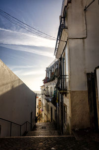 Narrow alley amidst buildings against sky