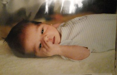 High angle view of baby boy sleeping on bed at home