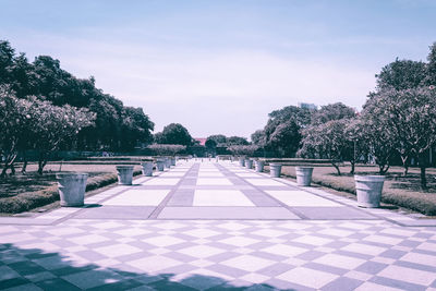 Footpath in park against sky