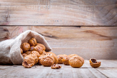 Close-up of walnuts in sack on table