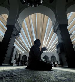 Rear view of man sitting on steps