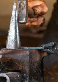 Cropped image of man repairing metal