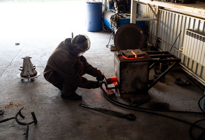 High angle view of boy working in container