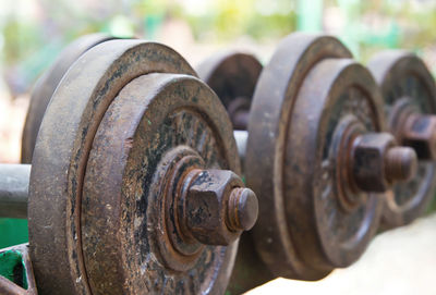 Close-up of rusty dumbbells on rack