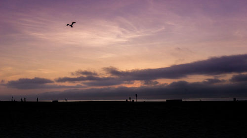 Scenic view of silhouette landscape against sky at sunset