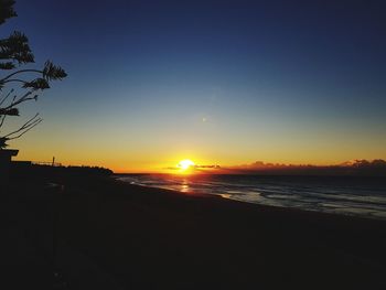 Scenic view of sea against clear sky during sunset