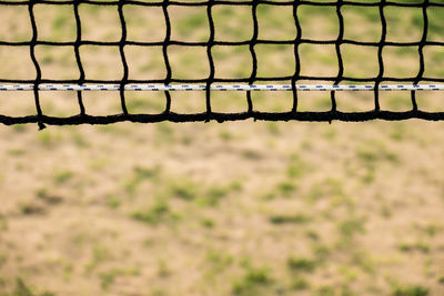 Close-up of volleyball net at beach