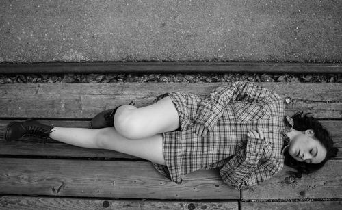 High angle view of girl lying on the tracks