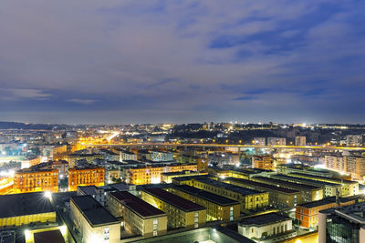 High angle view of illuminated cityscape against sky at night