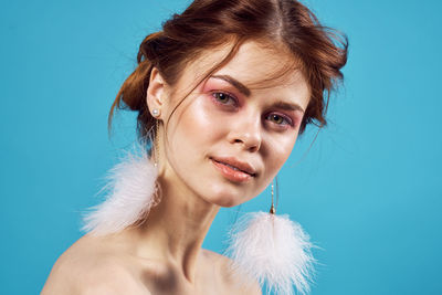 Portrait of woman against blue background