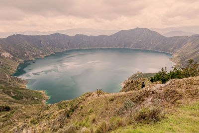 Scenic view of mountains against cloudy sky