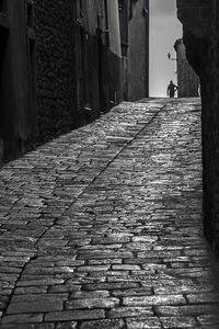 View of cobblestone street in city