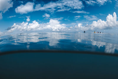 Airplane flying over sea against sky