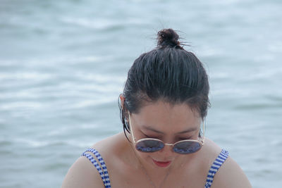 Woman wearing sunglasses against sea