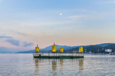 Last lights of the sunset in velden. reflections on the water and christmas atmosphere. austria.