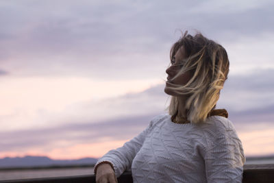 Rear view of woman looking at sunset