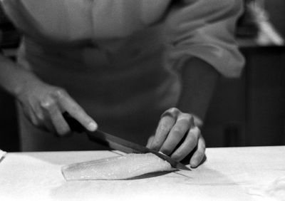 Woman cutting fish