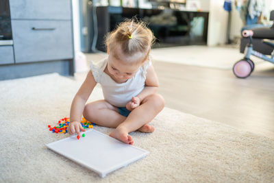High angle view of cute girl playing with toy at home