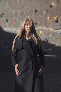 Portrait of young woman standing on street