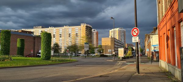 Road amidst buildings against sky in city