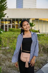 Portrait of a smiling young woman standing outdoors