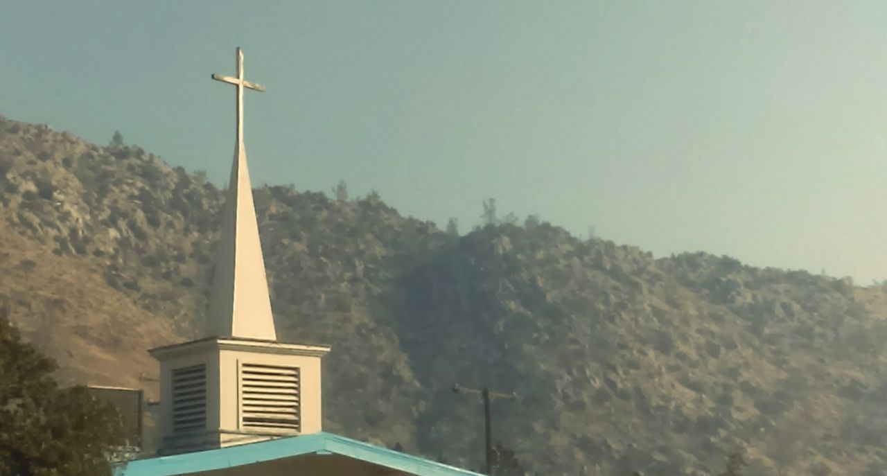 CROSS IN TEMPLE AGAINST SKY