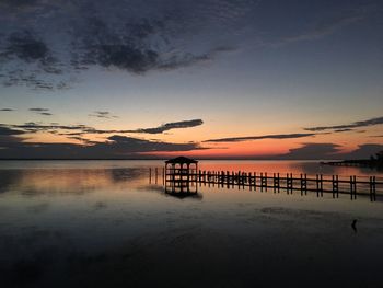 Pier on calm lake at dusk