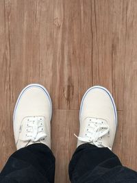 Low section of woman standing on tiled floor