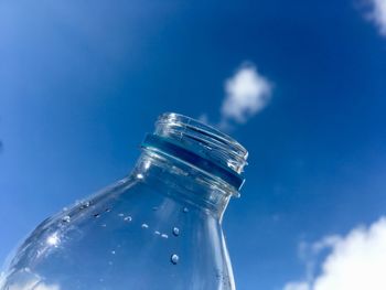 Low angle view of light bulb against blue sky