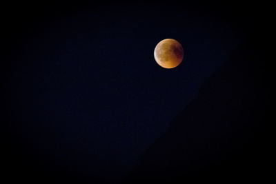 Low angle view of moon against sky at night