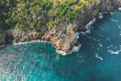 High angle view of rocks on sea shore