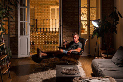 Man sitting on sofa at home