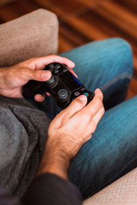 Midsection of man holding camera