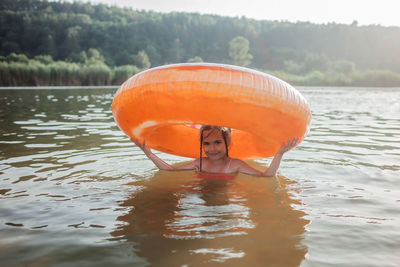 Young woman swimming in lake