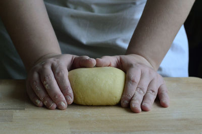 Close-up of man preparing food on table