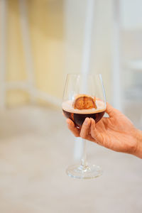 Midsection of person holding ice cream in glass