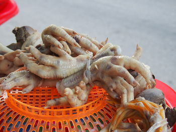 Close-up of chicken legs for sale at market stall