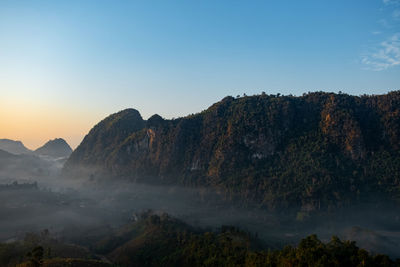 Scenic view of mountains against sky during sunset