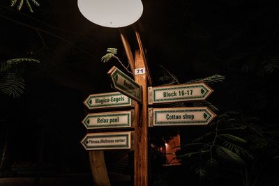Information sign against trees at night
