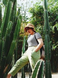 Side view of young man looking at plants