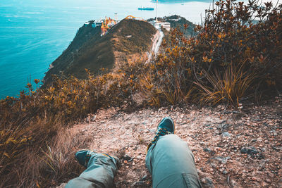 Man resting on the hiking trail at brick hill nam long shan that overlooks ocean park, hong kong