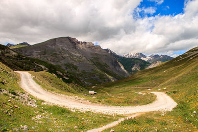 Mountain road passing by a lonely house