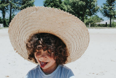 Boy wearing hat at beach
