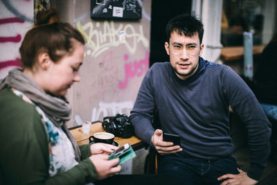 Portrait of young man holding camera