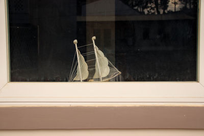 Close-up of toy boat at a window sill at home